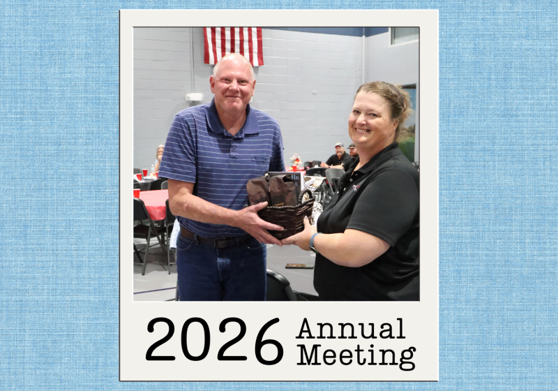 2026 Annual Meeting prize drawing recipient receiving a gift basket from a High West Energy employee during the event.
